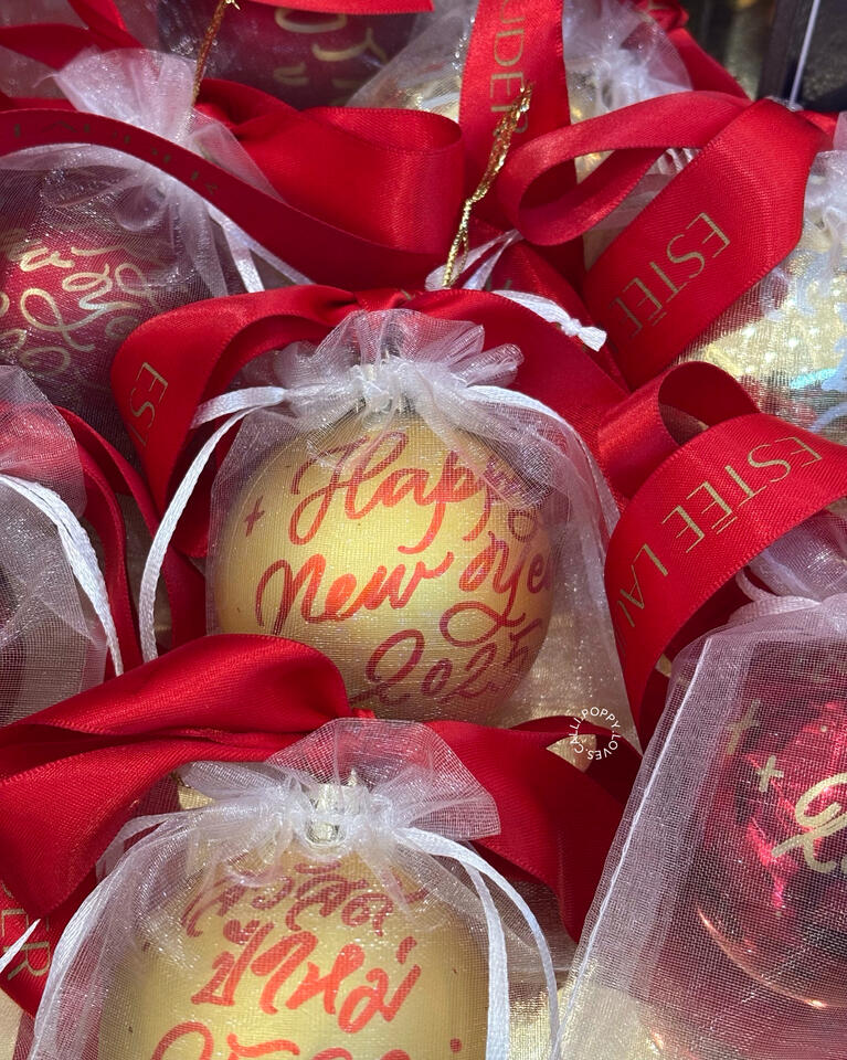 Hand-painting Calligraphy on Christmas Baubles for ESTĒE LAUDER